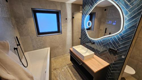 a bathroom with a sink and a mirror at Apartment Gosauschmied in Gosau