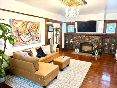 a living room with a couch and a fireplace at The House Hotel Elmwood in Lakewood
