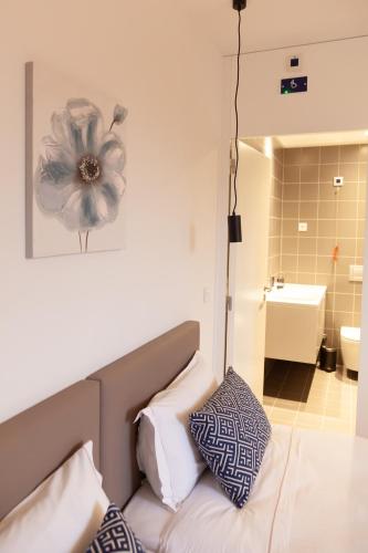 a bedroom with a bed with a flower picture on the wall at Poetikblue by We Do Living in Porto