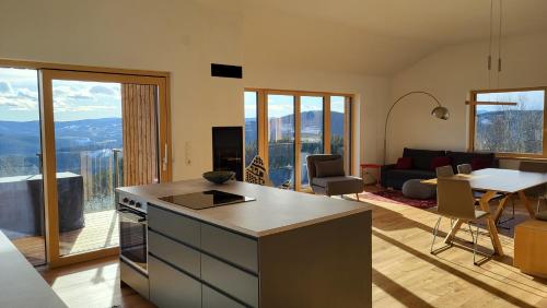a kitchen and living room with a view of the mountains at Haus am Hochwechsel in Breitenbrunn