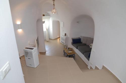 a view of a living room with a couch at Santorini Cave Suite in Éxo Goniá