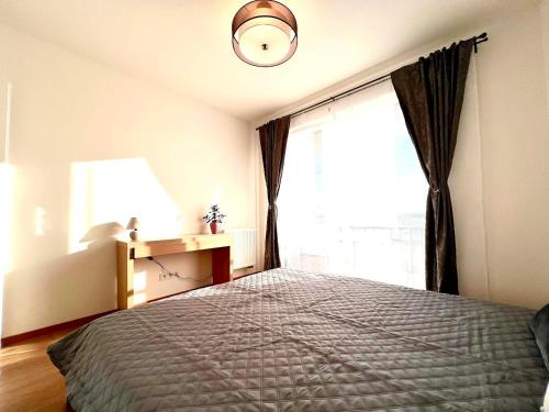 a bedroom with a bed and a large window at AR ALBELLI HOUSE in Košice