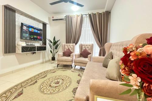 a living room with a couch and two chairs and a tv at Alanis Suite With Netflix @ KLIA Sepang in Sepang