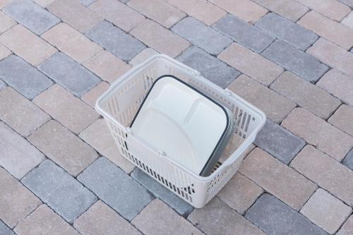 a white plastic basket sitting on a brick sidewalk at 【南房テラス】180度パノラマオーシャンビュー絶景を楽しむリゾート別荘の家 in Kanaya