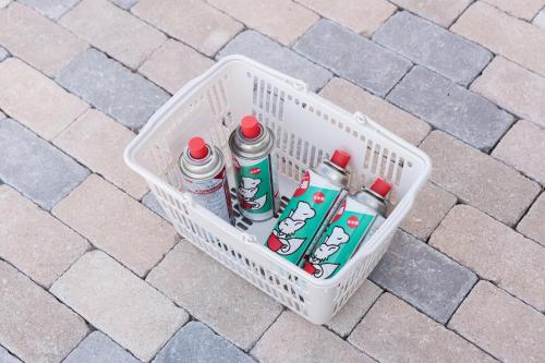 a basket full of water bottles on a brick floor at 【南房テラス】180度パノラマオーシャンビュー絶景を楽しむリゾート別荘の家 in Kanaya
