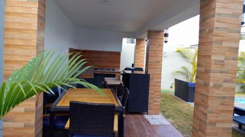 an outdoor patio with a wooden table and chairs at Ark Villa in Punta Cana