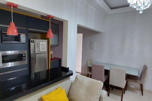 a kitchen with a couch and a table in a room at Casa Itapema/SC pertinho do mar! in Itapema