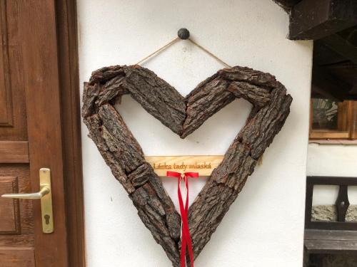 a heart shaped wreath hanging on a door at Chaloupka u Jiřího in Nová Pec