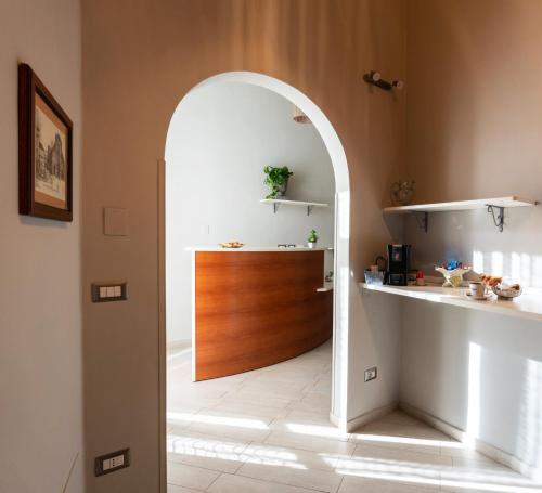 an archway leading into a kitchen with a wooden door at CONTE CAVOUR in Messina