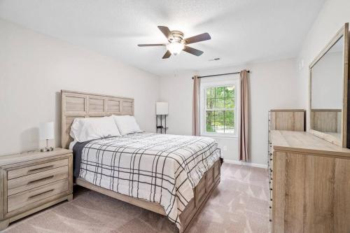 a bedroom with a bed and a ceiling fan at Beautiful Home Walking Distance to Elon University in Elon