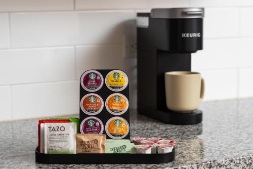 a counter with a coffee maker and a box of chips at Mint House Nashville - Music Row in Nashville