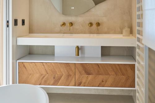 a bathroom with a sink and a mirror at Villa Sabaou Feng Shui Biarritz Spa Piscine in Biarritz
