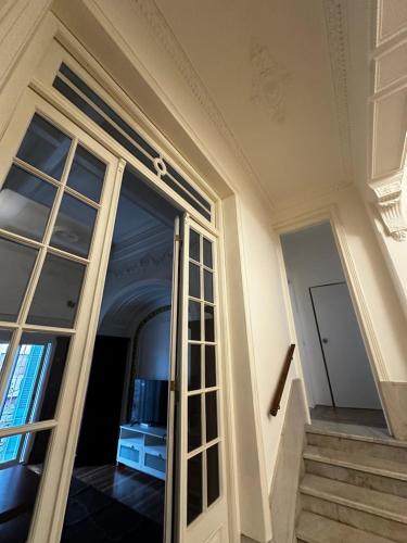 a sliding glass door in a building with stairs at Rococo Apart in Montevideo