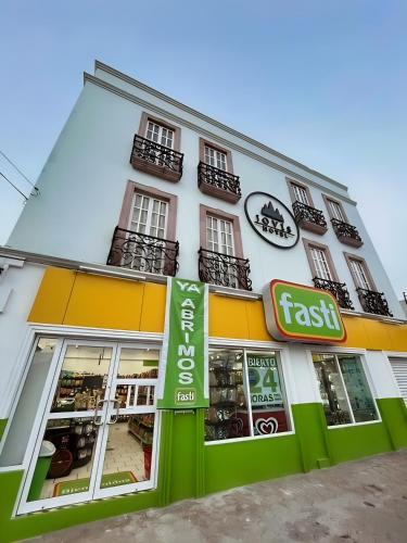 a fast food store with a sign in front of it at Jovis Hotel - Lujo Cultural in Villa Aldama