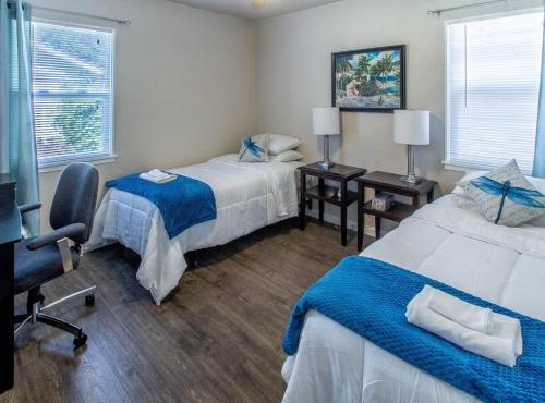 a hotel room with two beds and a desk at House of Favor in Redding