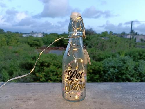 a message in a bottle with lights in it at Cozy Lodge in Grand Gaube