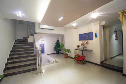 a lobby with stairs and a christmas tree in it at Nile Guardian Hotel in Cairo