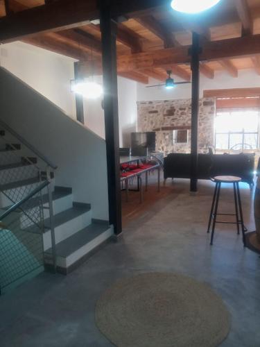 a living room with a staircase and a table at Casa Buscareta in Montán