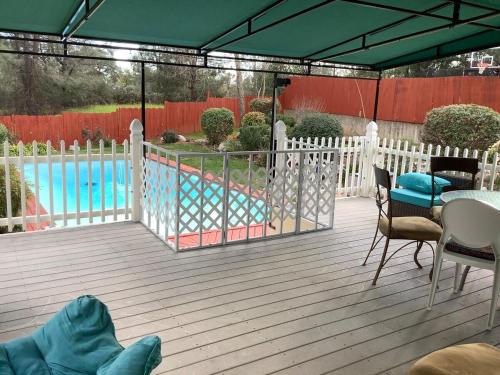 a deck with a fence and a swimming pool at Jacob's Well in Redding