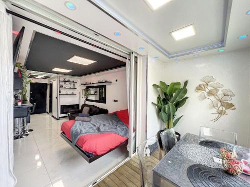 a bedroom with a bed and a living room at 12 Phantasm in Cap d'Agde
