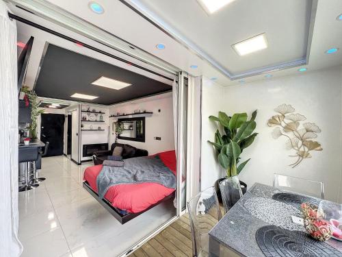 a bedroom with a bed and a living room at C12 Deluxe in Cap d'Agde