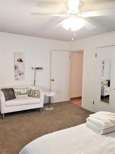 a living room with a white couch and a table at Jacob's Well in Redding