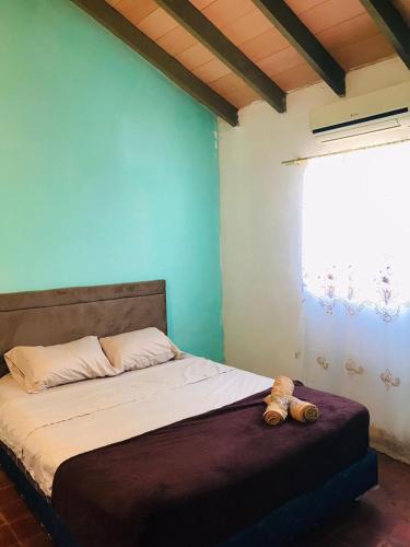 ein Schlafzimmer mit einem Bett mit einem Teddybär drauf in der Unterkunft Grecovich House in Encarnación