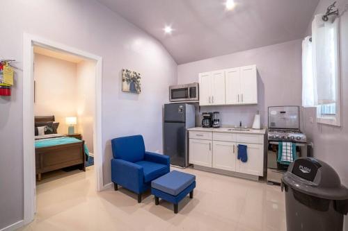 a kitchen with a blue chair and a refrigerator at Blue Haven (Mercy's Place) in Buckleys