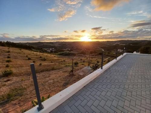 a view of the sunset from the roof of a house at Terraços da Serra in Painho
