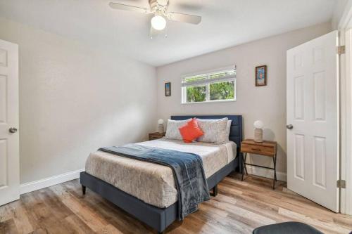 a bedroom with a bed and a ceiling fan at Chic & Cozy 3 Bed/2 Bath House Near Beaches in Largo