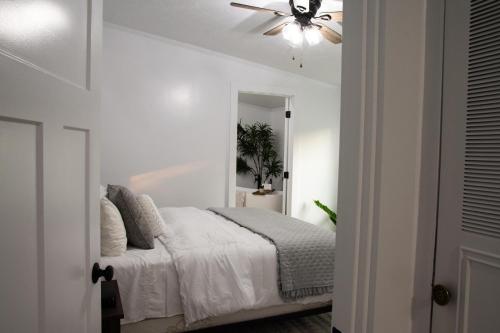 a bedroom with a bed with a ceiling fan at Maple Retreat with Big Pool in Dundee