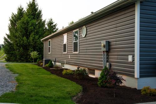 a house with a mailbox on the side of it at Maple Retreat with Big Pool in Dundee