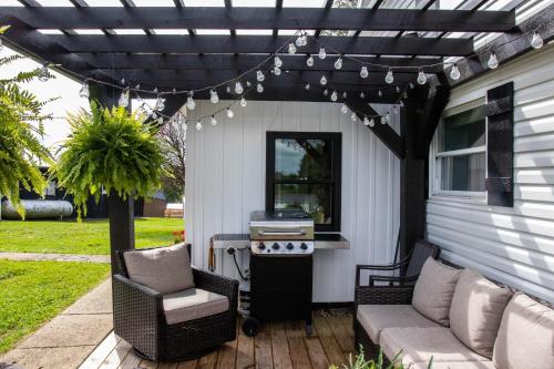 a pergola over a patio with a grill at Farmhouse of Blessings in Dundee