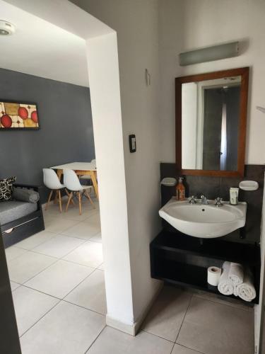 a bathroom with a sink and a mirror at MAKTUB DEPARTAMENTOS Y HABITACIONES in Alta Gracia