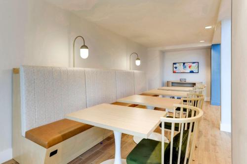 a row of tables and chairs in a restaurant at Sonesta Select San Francisco Airport Oyster Point Waterfront in South San Francisco