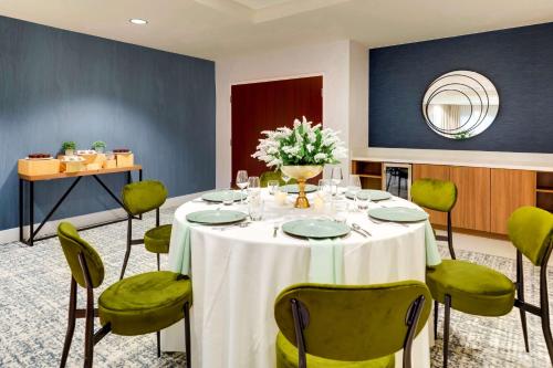 a room with a table and chairs and a mirror at Sonesta Select San Francisco Airport Oyster Point Waterfront in South San Francisco