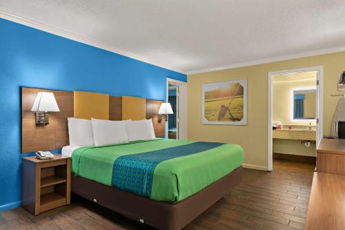 a hotel room with a large bed and a television at SureStay Hotel by Best Western Clermont Theme Park West in Kissimmee