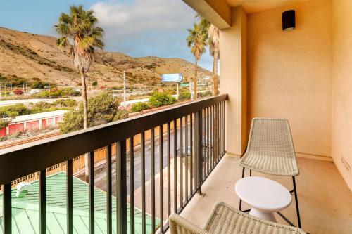a balcony with chairs and a view of a pool at Sonesta Select San Francisco Airport Oyster Point Waterfront in South San Francisco