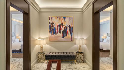 a hallway with a bench in a hotel room at Mansard Riyadh, a Radisson Collection Hotel in Riyadh