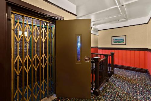 a hallway with a door with stained glass at Mithila San Francisco - SureStay Collection by Best Western in San Francisco