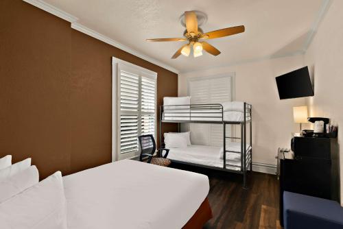 a bedroom with two bunk beds and a ceiling fan at Mithila San Francisco - SureStay Collection by Best Western in San Francisco