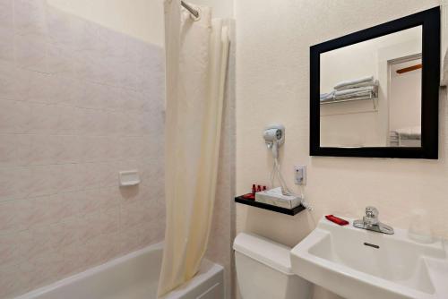 y baño con lavabo y ducha con espejo. en Mithila San Francisco - SureStay Collection by Best Western en San Francisco