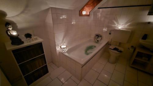 a bathroom with a tub and a toilet at Surforama Studio Apartment mit Meerblick und Garten in Fehmarn