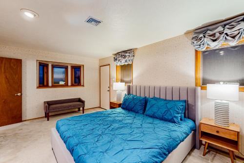 a bedroom with a blue bed in a room at Pacific Princess in Crescent City