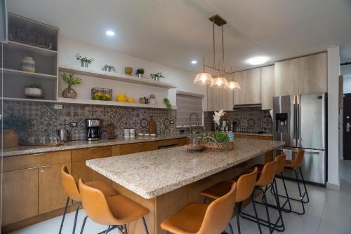 a kitchen with a large island with a counter top at Viñedos del Mar in Ensenada