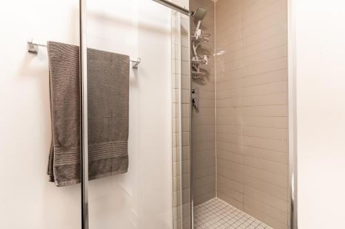 a shower stall with a glass door in a bathroom at One bedroom apartment - 507 in Montreal