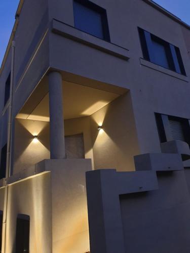 a building with lights on the side of it at Poetikblue by We Do Living in Porto