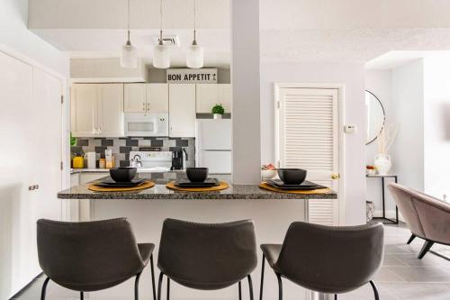 a kitchen with a counter with chairs and a table at Viola’s Place in Washington