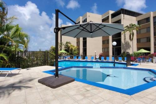 a pool at a hotel with an umbrella at Moon Bay Condo, Paradise Found in Sunny Key Largo, Florida in Key Largo
