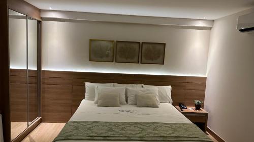 sypialnia z dużym łóżkiem z białą pościelą w obiekcie Vista Azul Hotel w mieście Domingos Martins